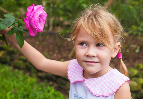 Girl with flower in hand — Stock Photo, Image