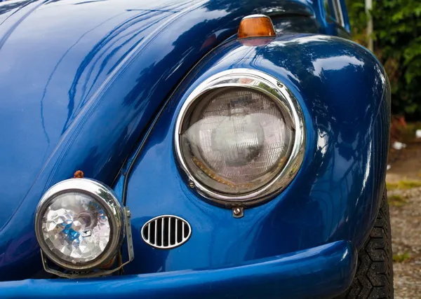 Bumper and twin headlamps of classic blue rally car — Stock Photo, Image