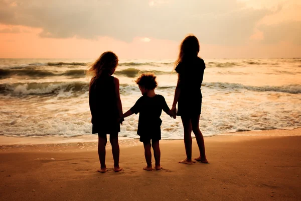 sad children on the beach