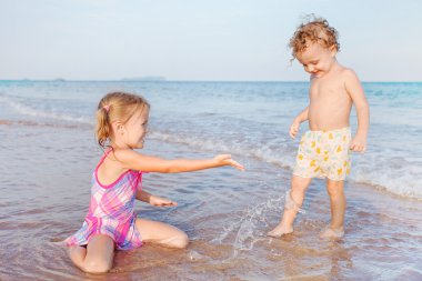 iki çocuk kumsalda oynarken