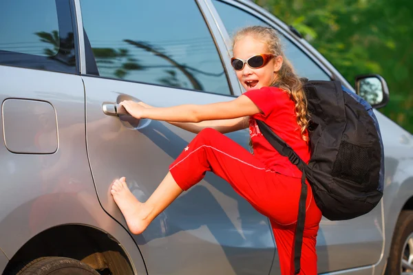 Glad tjej står nära bilen, redo att resa — Stockfoto