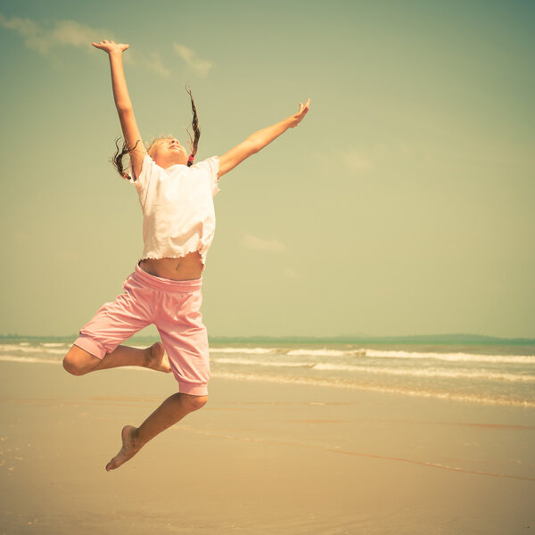 flying jump beach girl on blue sea shore in summer vacation