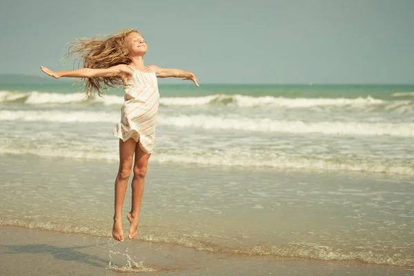 Flying jump beach girl on blue sea shore in summer vacation — Stock Photo, Image