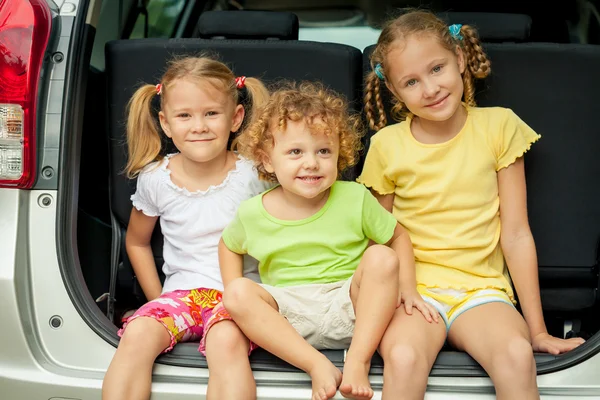 Trzy szczęśliwe dzieci w samochodzie — Zdjęcie stockowe