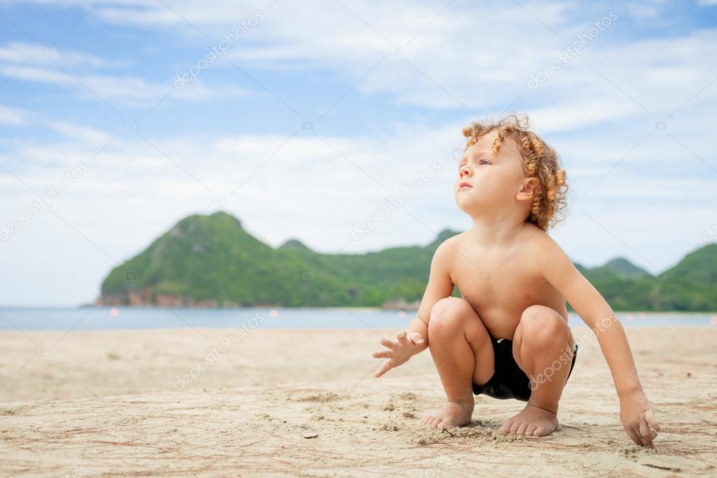Little boy playing on the beach.