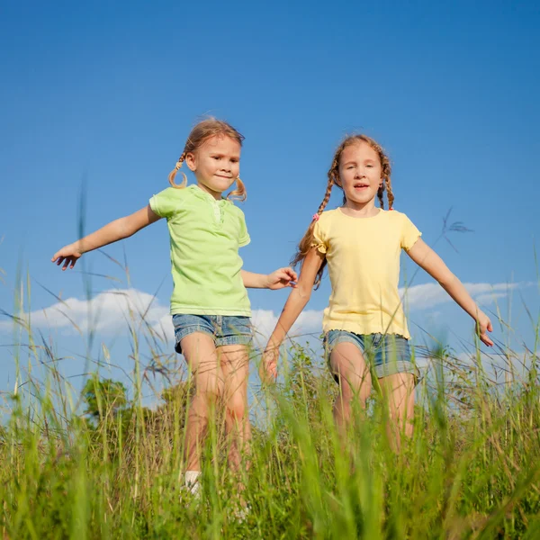 Two Girls jumping on the road — Stock Photo, Image