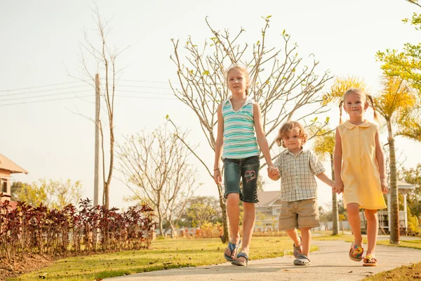 Two happy  girls and little boy on the nature — Stock Photo, Image