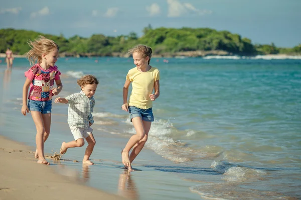 Happy kids playing on beach — Stock Photo, Image