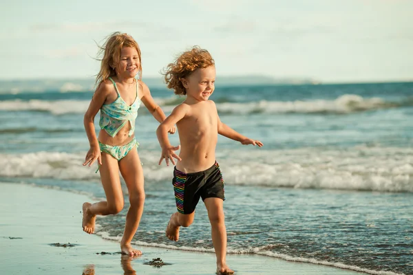 Happy kids playing on beach in the day time — Stock Photo, Image