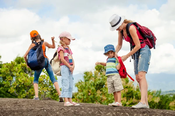 Three little kids and mother in the mountains — Stock Photo, Image