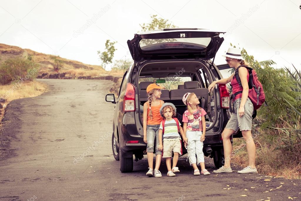 three little kids and mother in the mountains