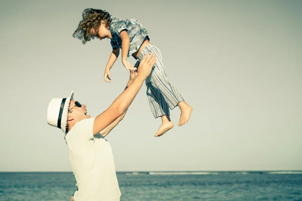 Father and son playing on the beach at the day time — Stock Photo, Image