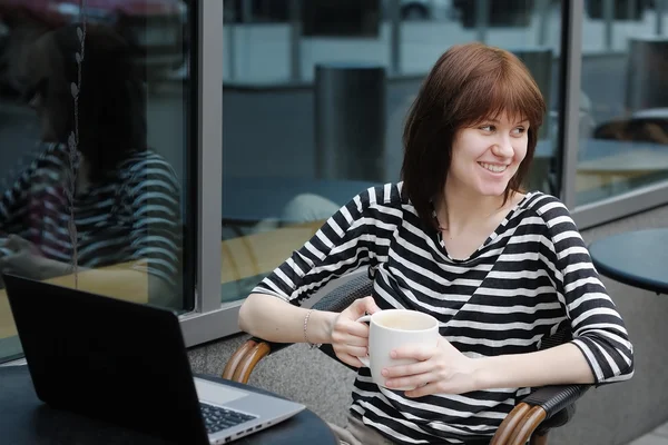 Happy girl drinking coffee in a outdoor cafe — Stock Photo, Image