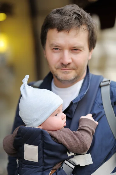 Father and his baby in a baby carrier — Stock Photo, Image