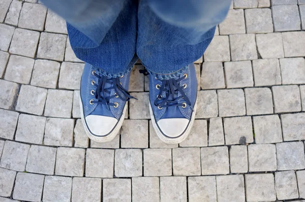 Feet shod in sneakers — Stock Photo, Image