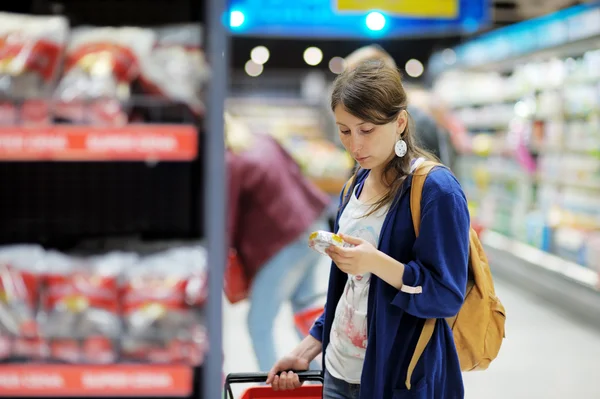 Jonge vrouw in supermarkt — Stockfoto