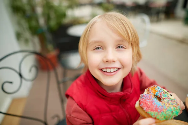 Cute School Age Boy Eating Funny Colorful Donut Street Cafe — Fotografia de Stock