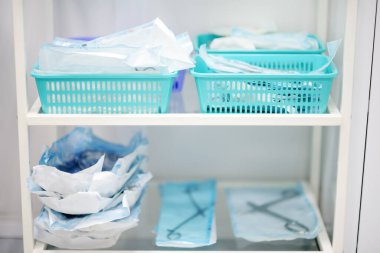 Table with sterile instruments in the operating room or doctor's office. Medical tools in disposable packages are ready for use
