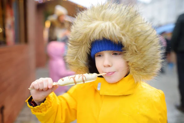 Little Boy Eating Fruit Chocolate Glaze Street Christmas Market Famous — Fotografia de Stock