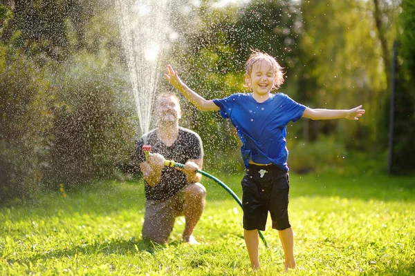 Funny Little Boy His Father Playing Garden Hose Sunny Backyard — 스톡 사진