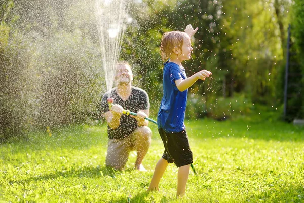 Funny Little Boy His Father Playing Garden Hose Sunny Backyard — 스톡 사진