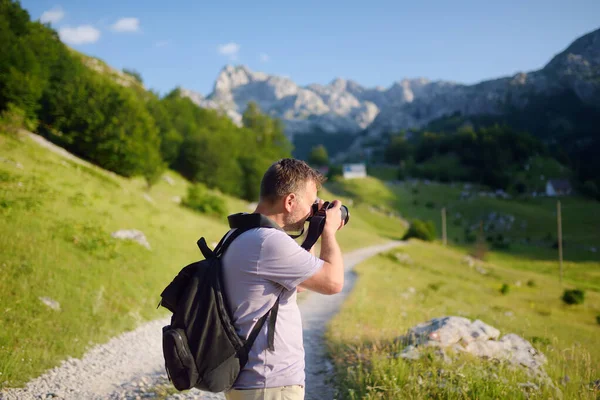 Mature Man Tourist Backpack Camera Hiking Mountain Valley Photographer Taking — Zdjęcie stockowe