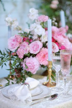 Stylish table set for an event party or wedding reception banquet. Beautiful and luxury decorations of table in restaurant or cafe