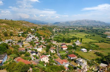 Picturesque view of neighborhoods Skodra in Albania on the background of mountains at sunny summer day, seen from Rozafa fortress. Travel and tourism.