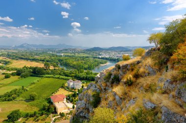 Aerial stunning view of neighborhoods Skodra in Albania on the background of mountains at sunny summer day, seen from Rozafa fortress. Travel and tourism.