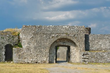 View of the famous Rozafa fortress near the city of Shkodra. Gates of the bastion lead through an ancient stone wall. The fort attracts visitors from all over the world. Travel and tourism in Balkan