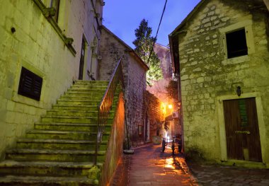 Empty street of Kotor old town at night. Historical buildings, cobblestone pavement, ancient churches are attraction for tourists on any season. Travel, tourism, sightseeing in Montenegro