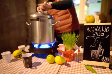 Preparation and sale of mulled wine on european Christmas market. Christmas holidays on fair in Kotor, Montenegro. Tradition of winter holidays. The sign says 