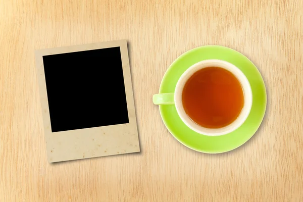 Cup tea and photo frame — Stock Photo, Image