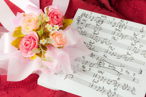 Rose on the musical notes — Stock Photo, Image