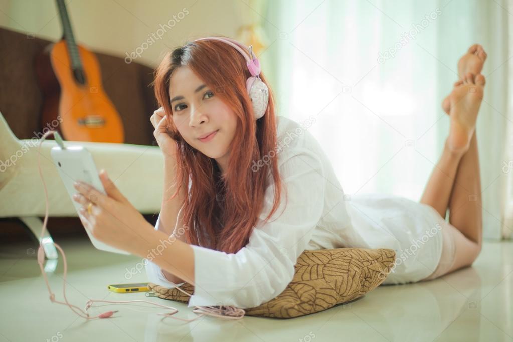Young asian woman listening to music