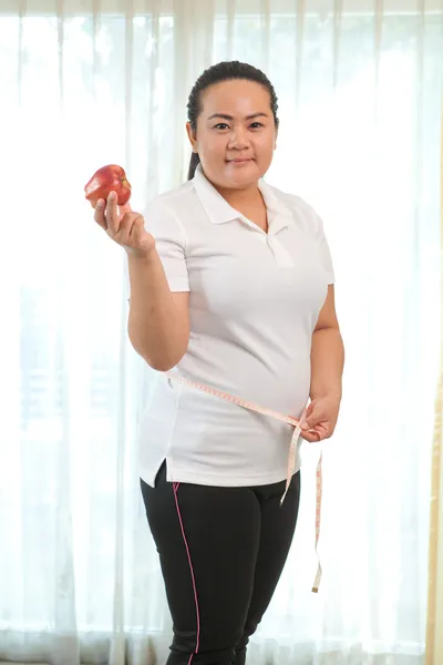 Fat woman with apple — Stock Photo, Image