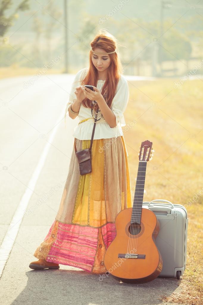 Hippie girl using mobile phone