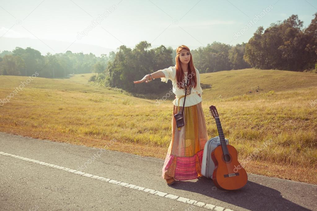Hippie girl hitchhiking