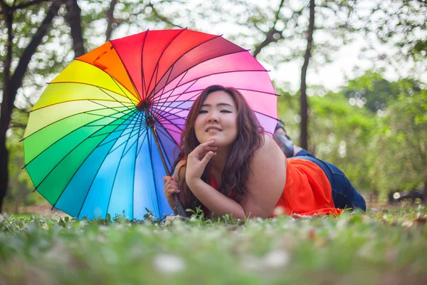 Happy fatty woman with umbrella — Stock Photo, Image