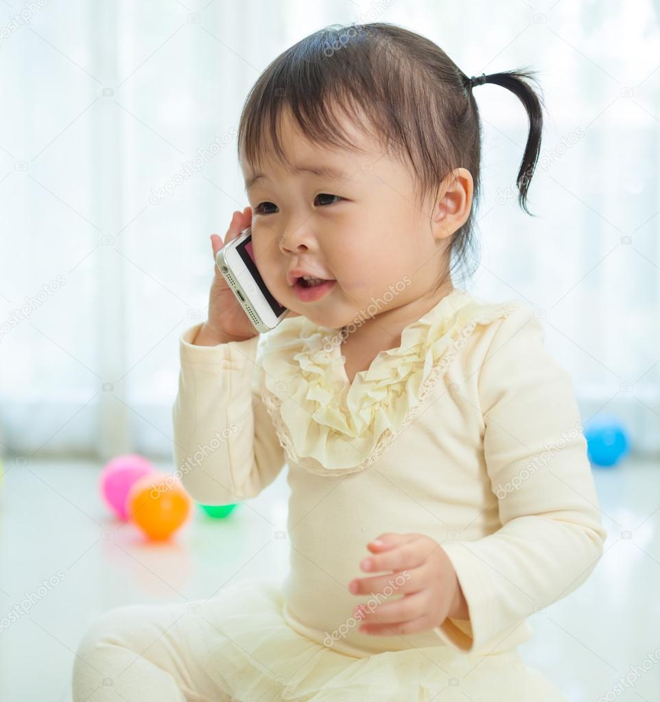 Little girl talking on mobile phone