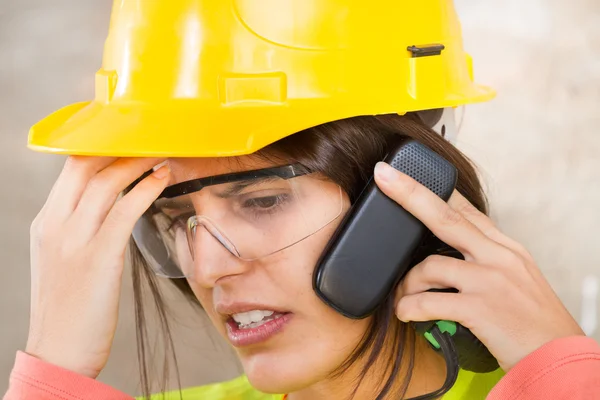 Portrait of a woman with safety helmet and mobile phone — Stock Photo, Image