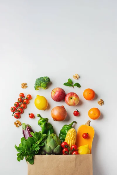 Delivery healthy food background. Healthy vegan vegetarian food in paper bag vegetables and fruits on white, copy space, banner. Shopping food supermarket and clean vegan eating concept.