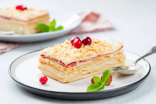 Two pieces of cake Napoleon on white plate. Russian cuisine, multi layered cake with pastry cream, close up view.