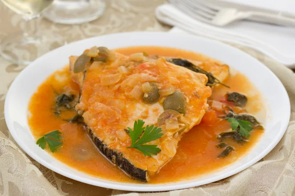 Fish in sauce on the plate — Stock Photo, Image