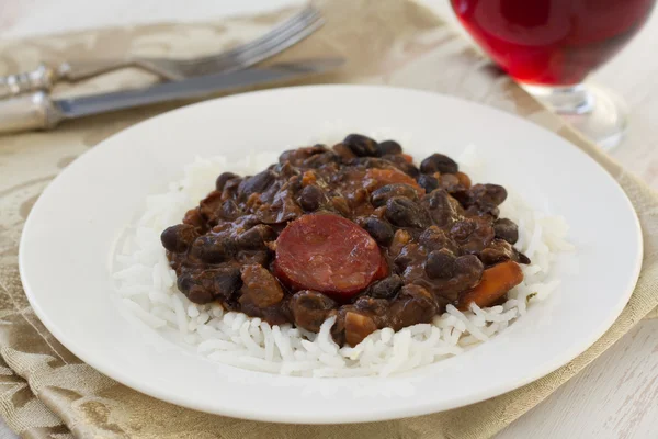 Black beans with chorizo and boiled rice — Stock Photo, Image