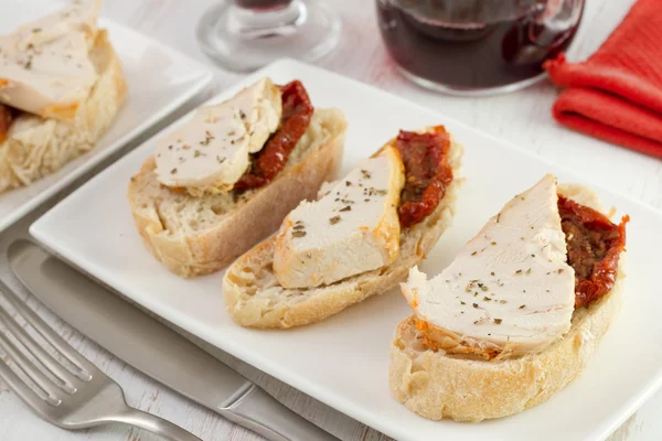 Bread with chicken and dry tomato on the plate — Stock Photo, Image