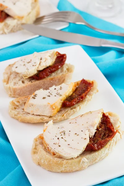 Bread with chicken and dry tomato on the plate — Stock Photo, Image