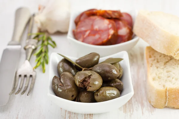 Olives with chourico, rosemary and garlic — Stock Photo, Image