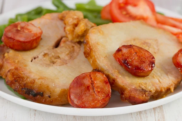 Pork with chorizo on the white plate — Stock Photo, Image