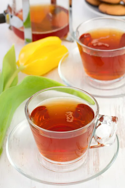 Cup of tea with one yellow tulip — Stock Photo, Image